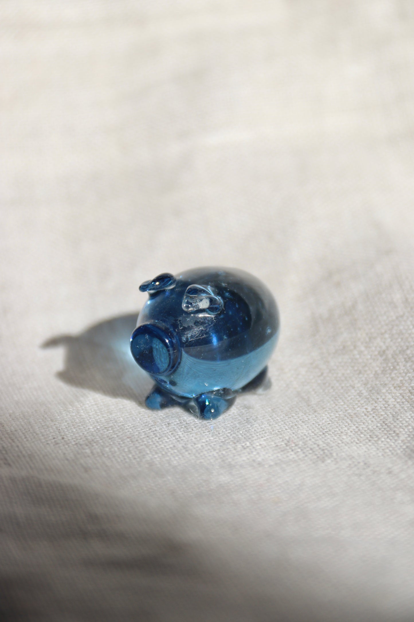 Miniature blue glass pig