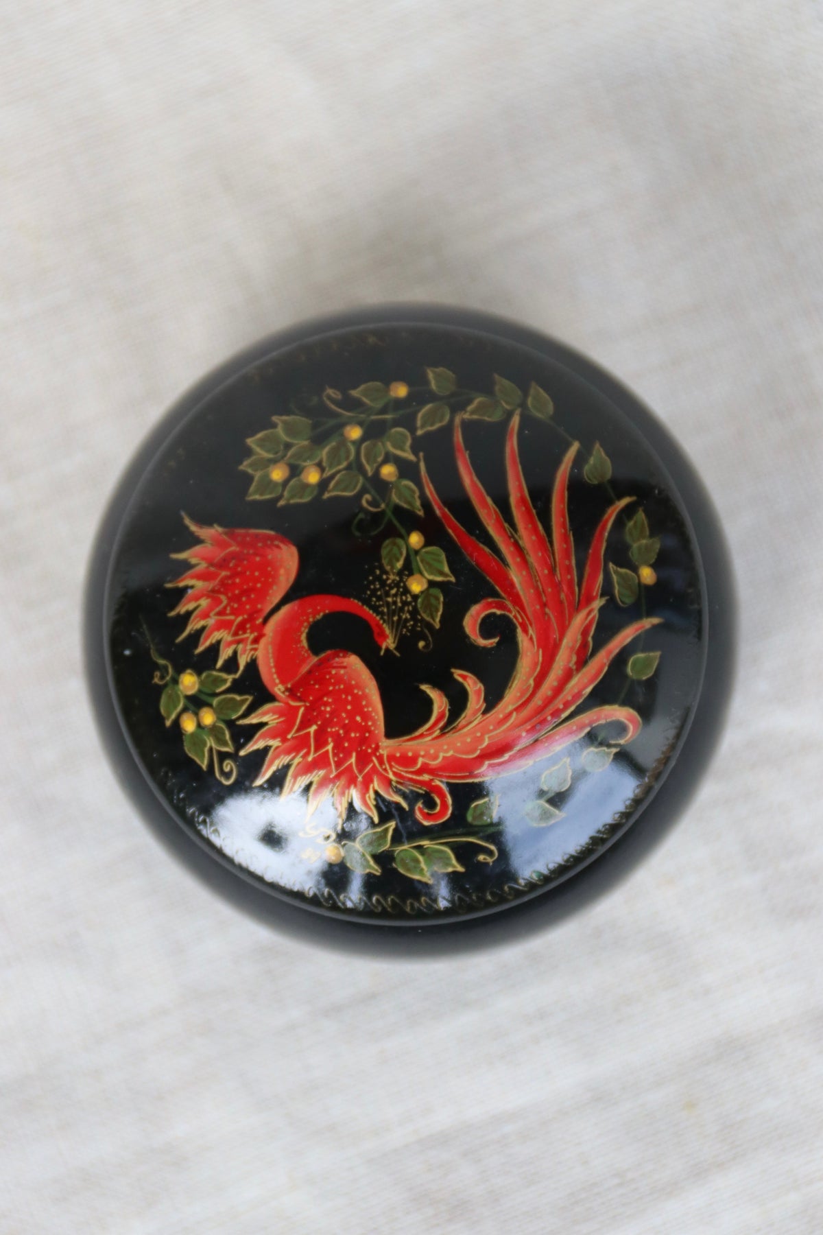 vintage Soviet-era hand-painted black lacquer trinket box with a red and gold Firebird or Phoenix design
