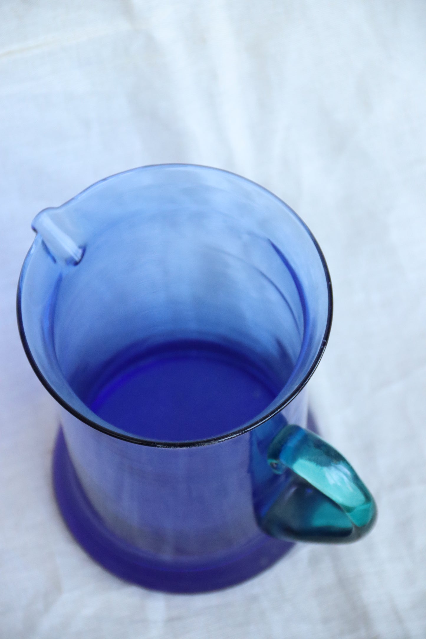 Vintage Blue Glass Pitcher with Teal Handle