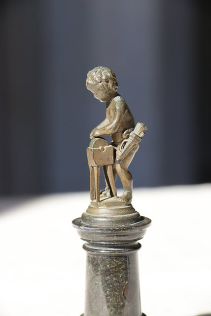 Miniature Bronze Figurine of Cupid Sharpening His Points on Marble Pedestal