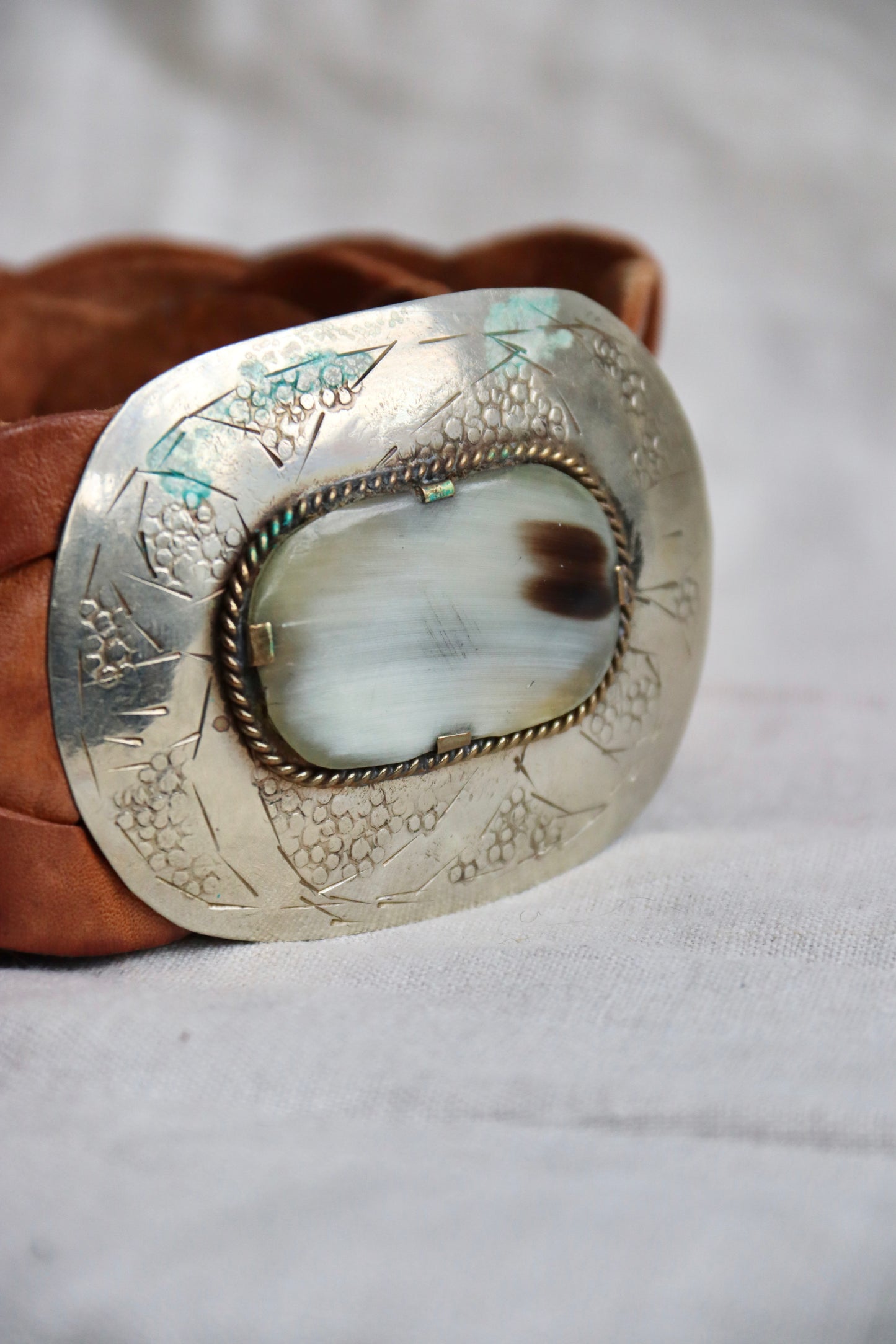 Brown braided leather belt with silver buckle