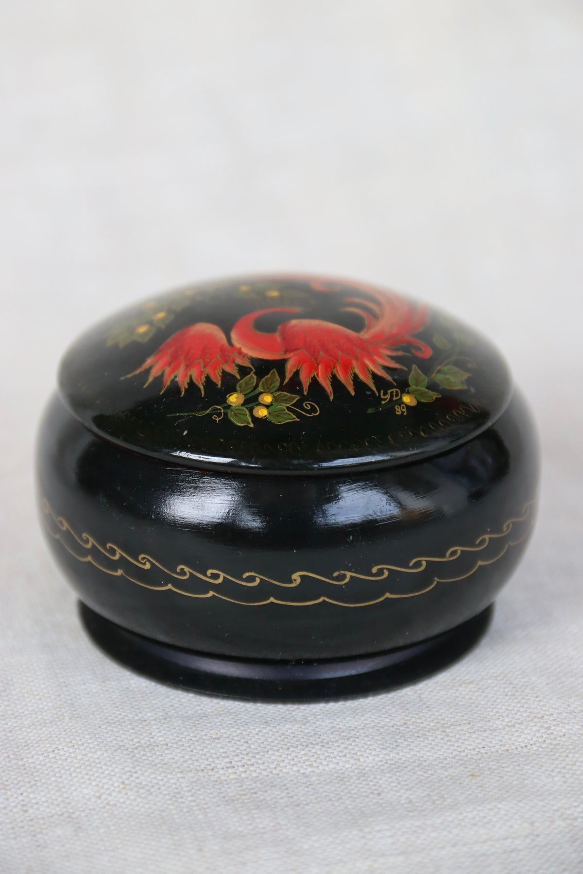 vintage Soviet-era hand-painted black lacquer trinket box with a red and gold Firebird or Phoenix design