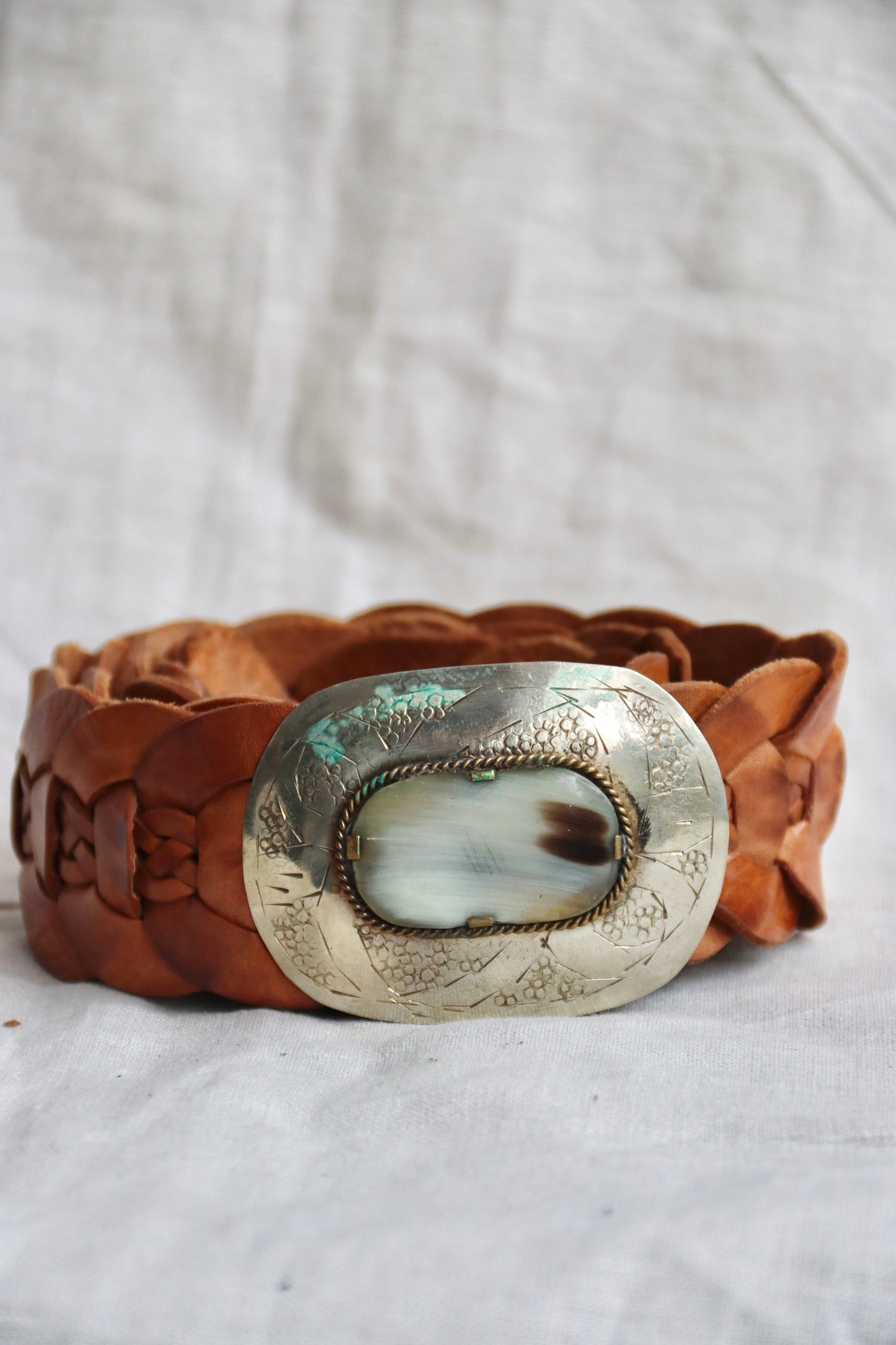 Brown braided leather belt with silver buckle