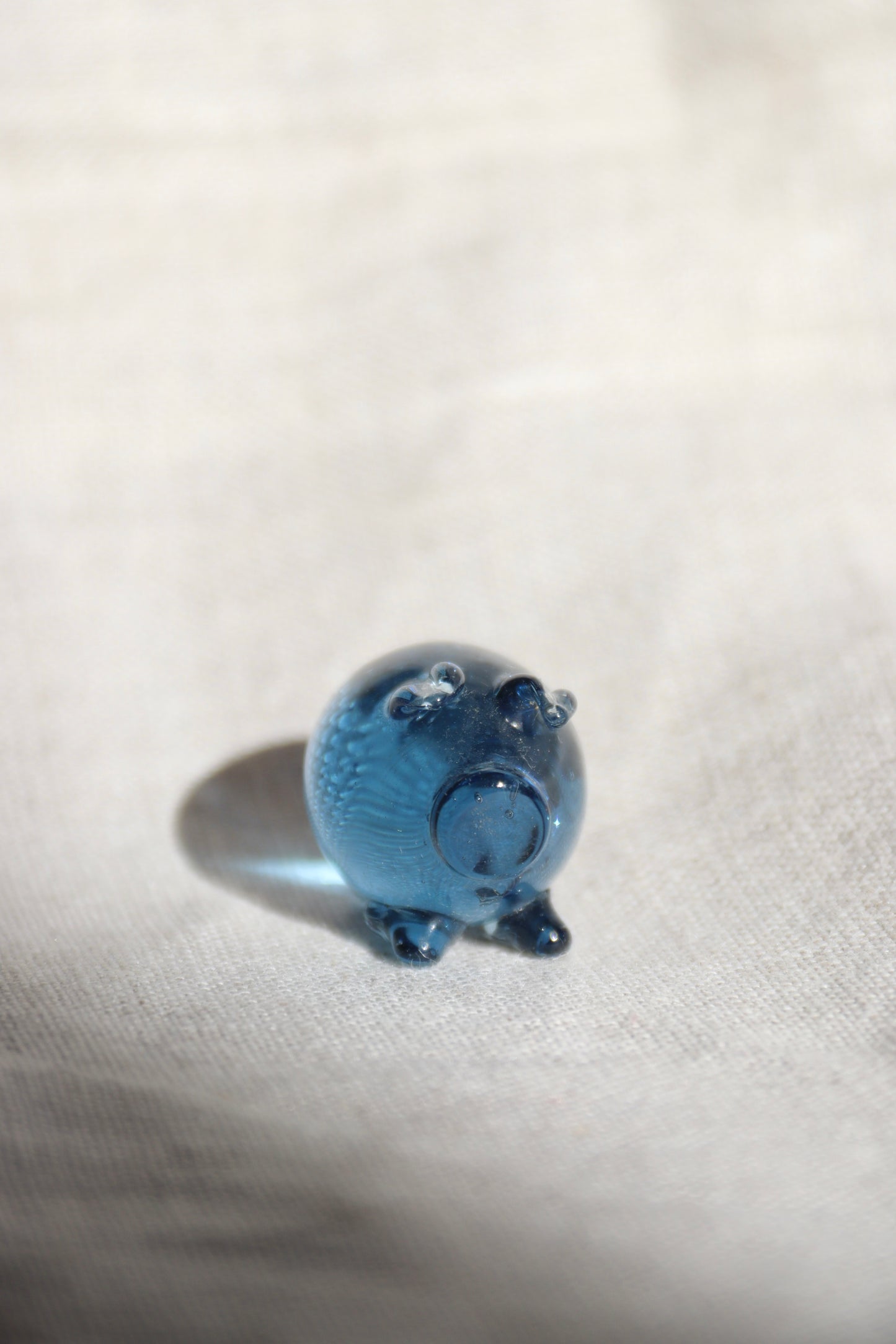 Miniature blue glass pig